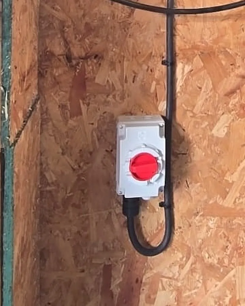 Rotary AC emergency isolator switch and clipped SWA cable containment route
