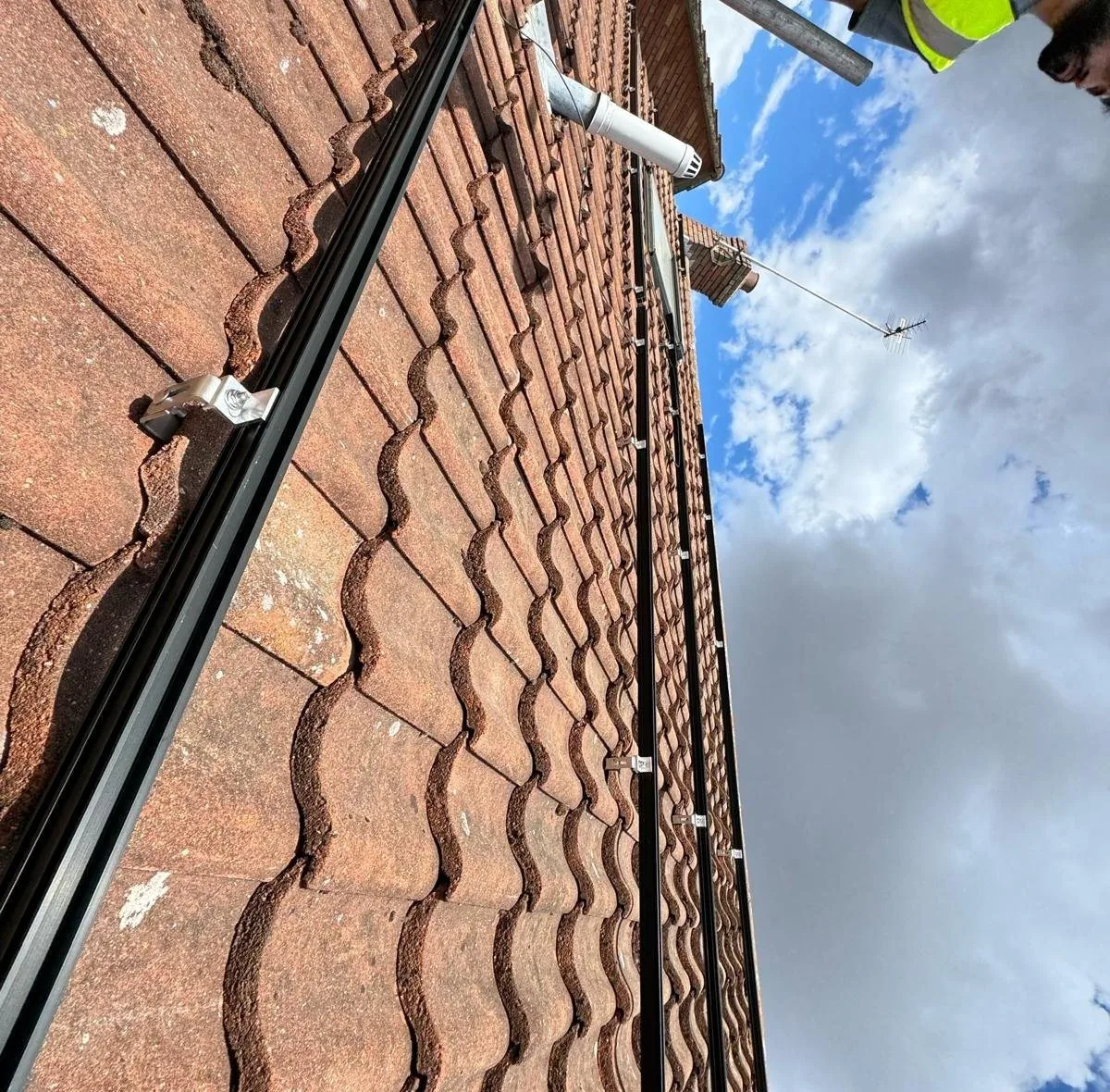 Black mounting rails on pantile roof at Bishops Stortford